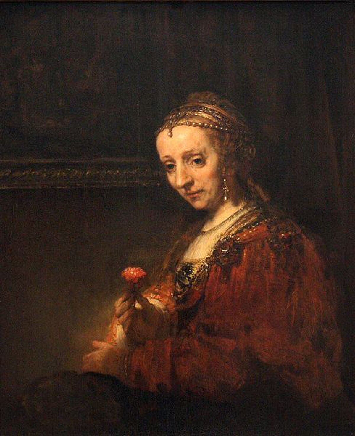 Woman with a Pink by Rembrandt van Rijn